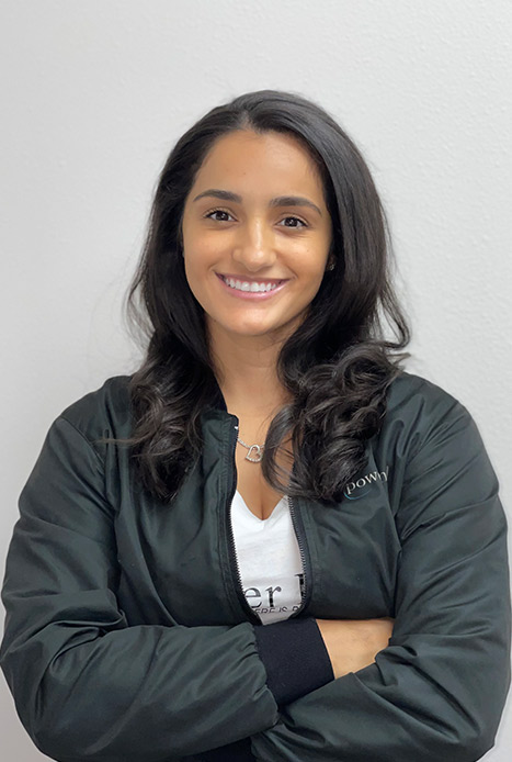 Dr. Jackson smiling while wearing a dark gray Empower Dental jacket over a white shirt.